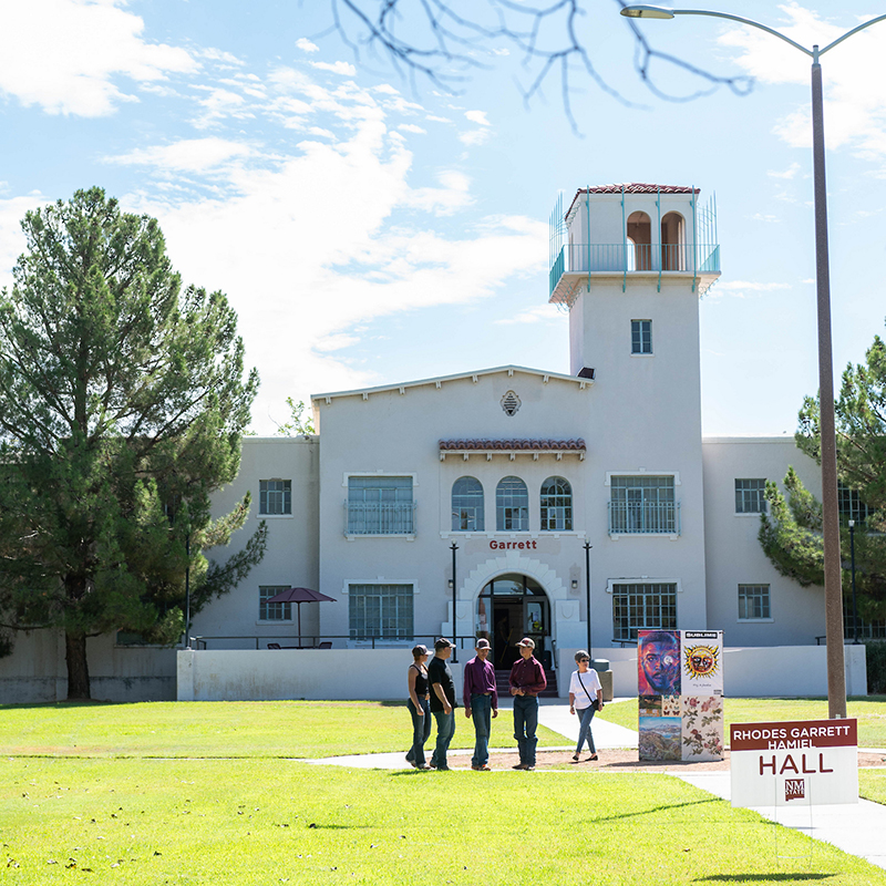 students walking in the grass in front of RGH dorms