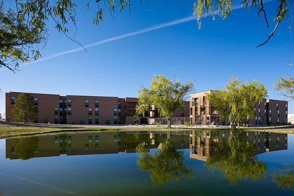 Chamisa Village exterior in the background of Alumni pond